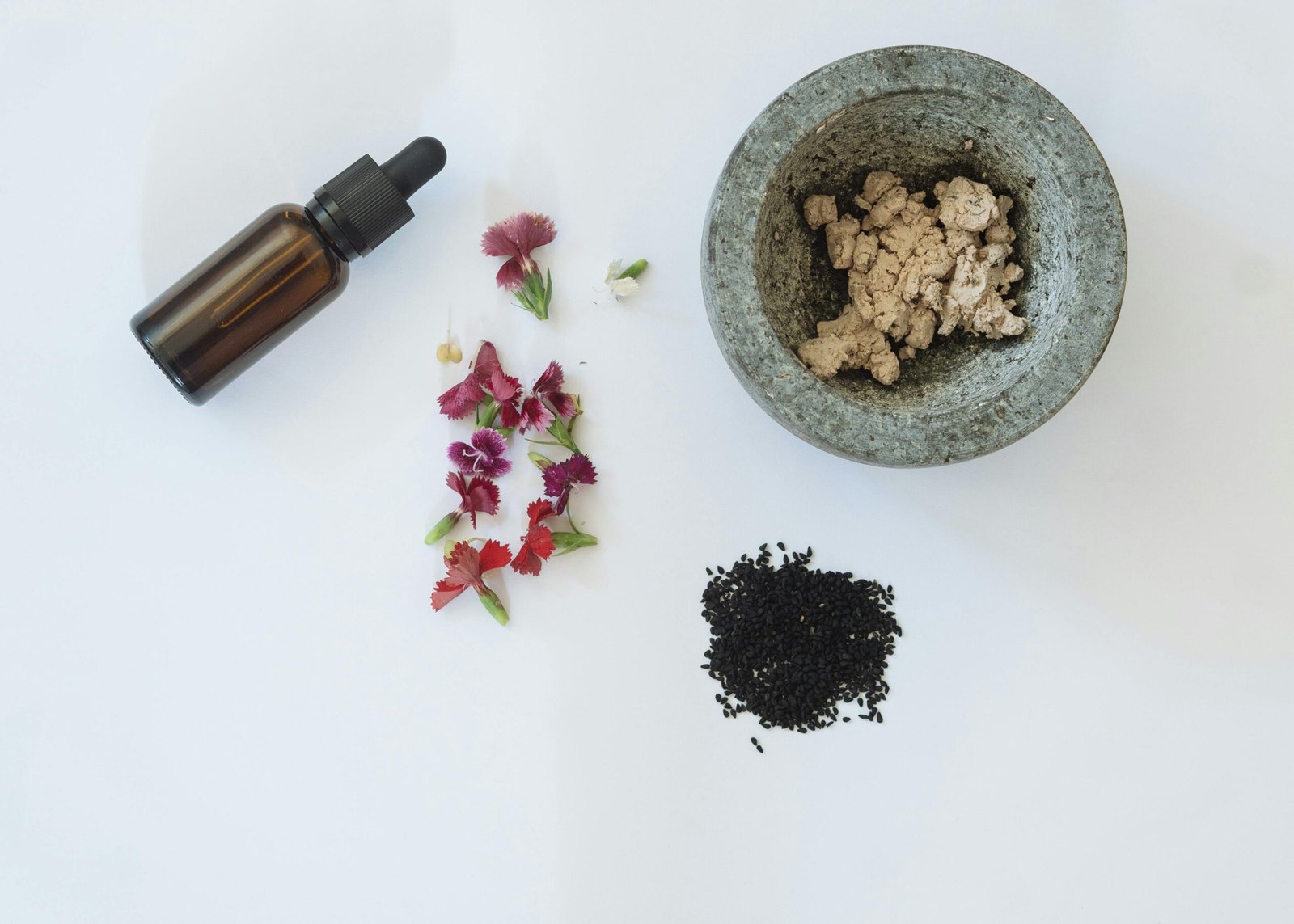 Flat lay of various skin care products, including creams and serums, arranged with natural elements